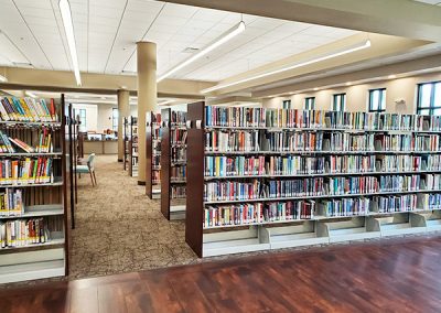 Several Rows of Book Shelves filled with books at the Punta Gorda Charlotte Library