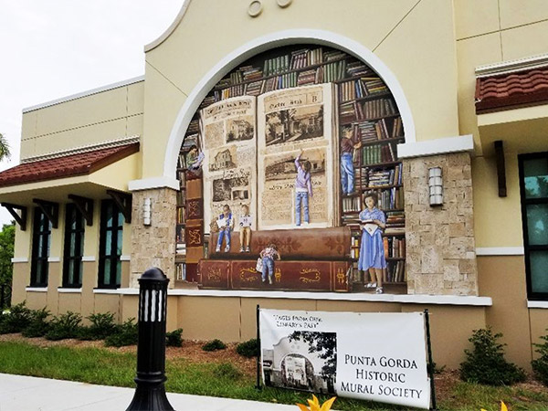 The Pages from Our Librarys Past mural on the side of the new Punta Gorda Charlotte Library